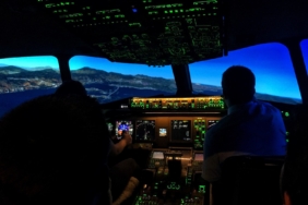 two men sitting on aircraft control panel